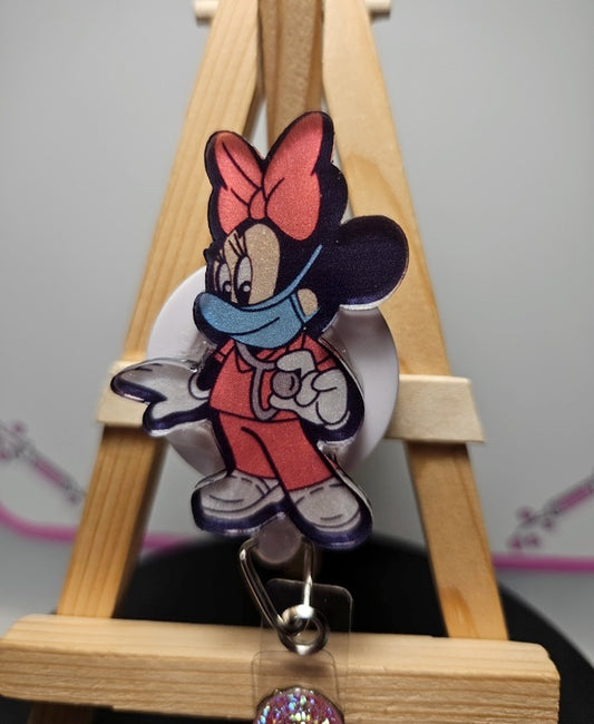Nurse cartoon character badge with metal clip; red uniform and bow headwear