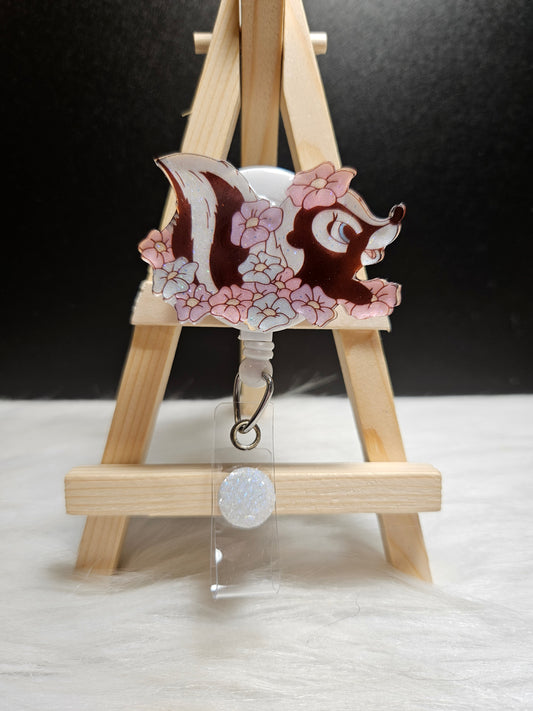 Skunk floral badge reel with metal clip and clear badge holder