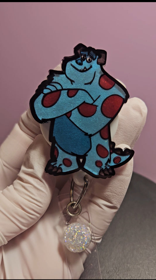 Sulley badge reel with blue cartoon character and glitter disc, metal clip