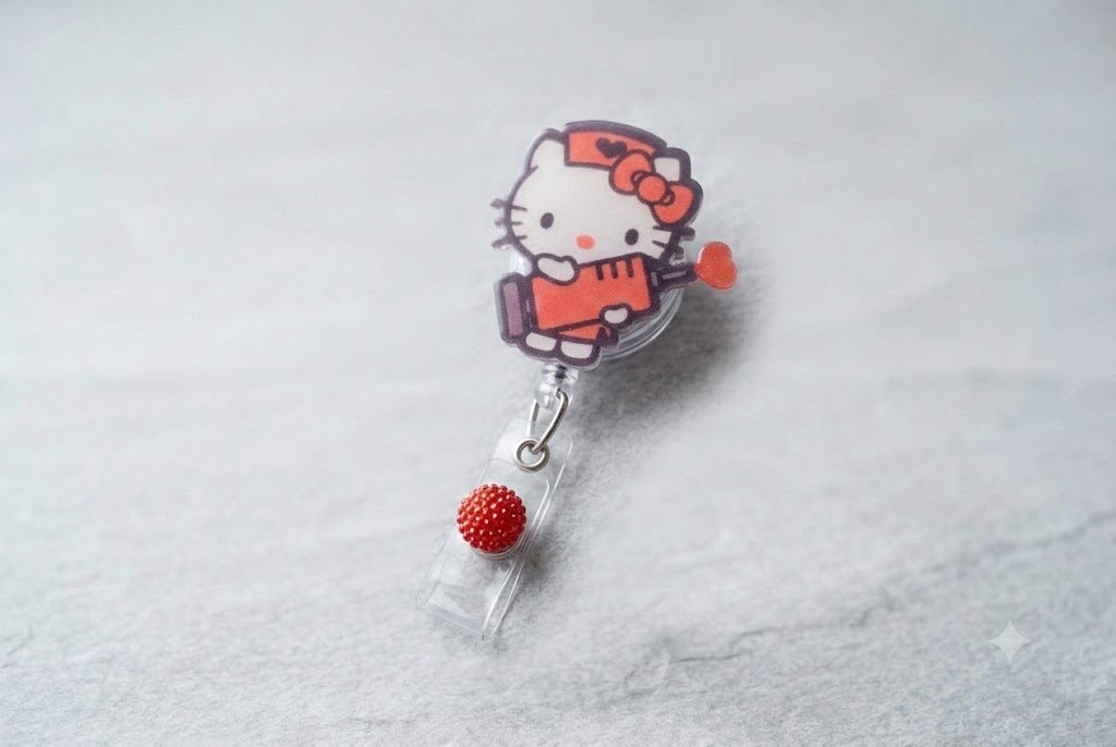HK badge reel with Hello Kitty figure and red beaded charm, metal loop clasp